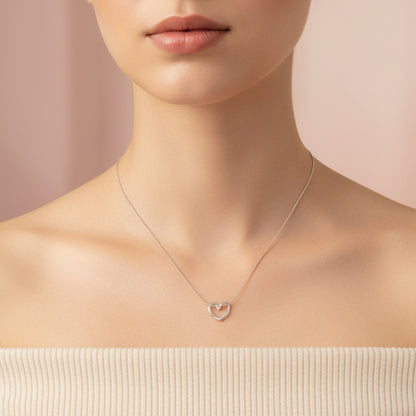 Elegant silver knot heart pendant necklace displayed on a model's neck with a soft background