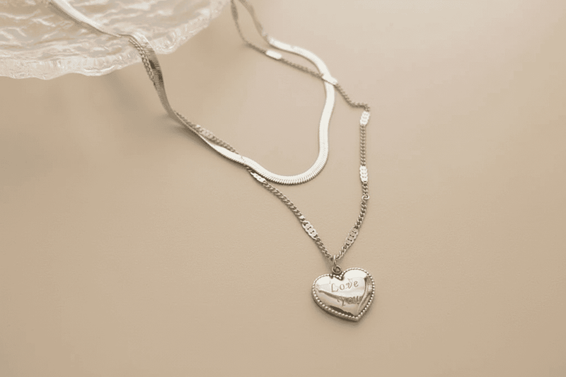 Silver layered heart necklace featuring a charming heart pendant engraved with the word Love