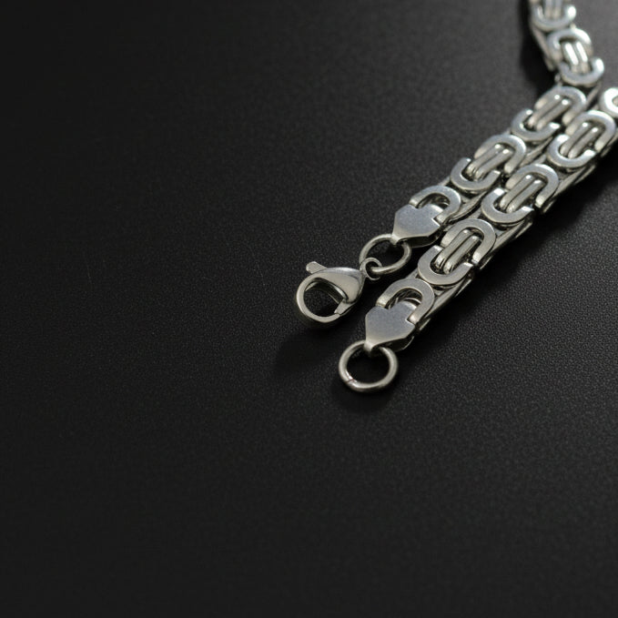 Silver-toned Byzantine bracelet featuring interlocking links for elegant styling