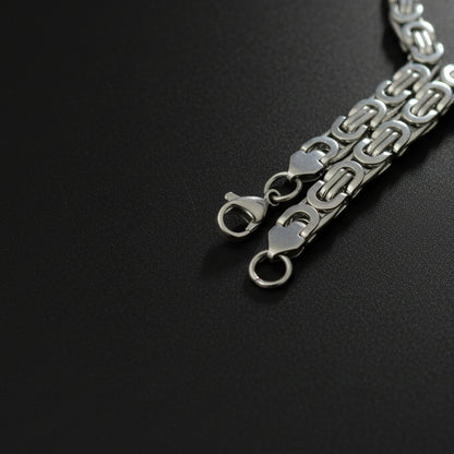 Silver-toned Byzantine bracelet featuring interlocking links for elegant styling