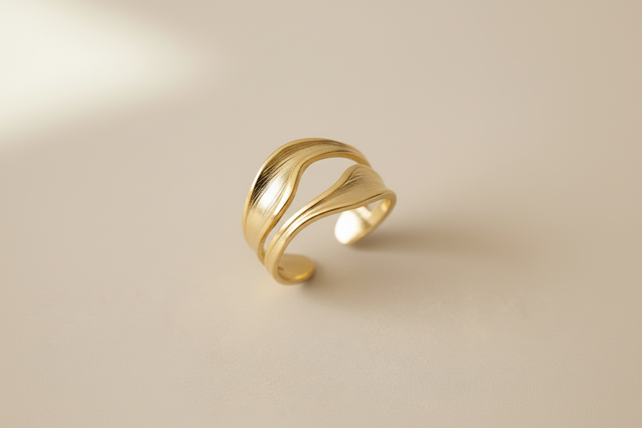 Lustre of Love gold wave ring in an elegant design, featuring a stainless steel adjustable size