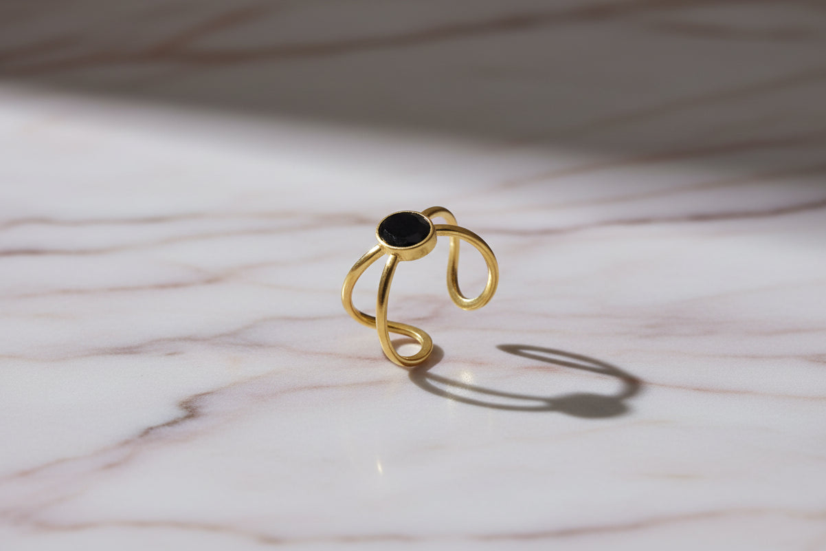 Lustre of Love gold ring with black stone, featuring stainless steel adjustable size for a perfect fit