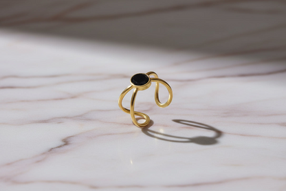 Lustre of Love gold ring with black stone, featuring stainless steel adjustable size for a perfect fit