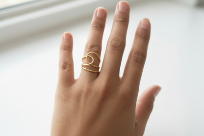 Gold Lustre of Love ring on a hand featuring a unique design with stainless steel adjustable size