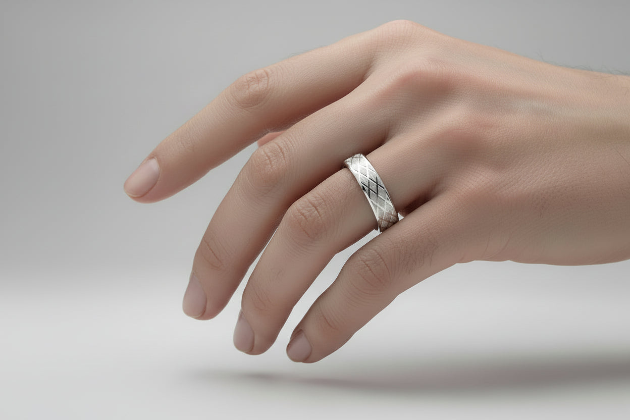 Elegant stainless steel silver ring with a textured design displayed on a hand